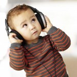 13485840-young-kid-wearing-headphones-and-listening-to-music-indoor